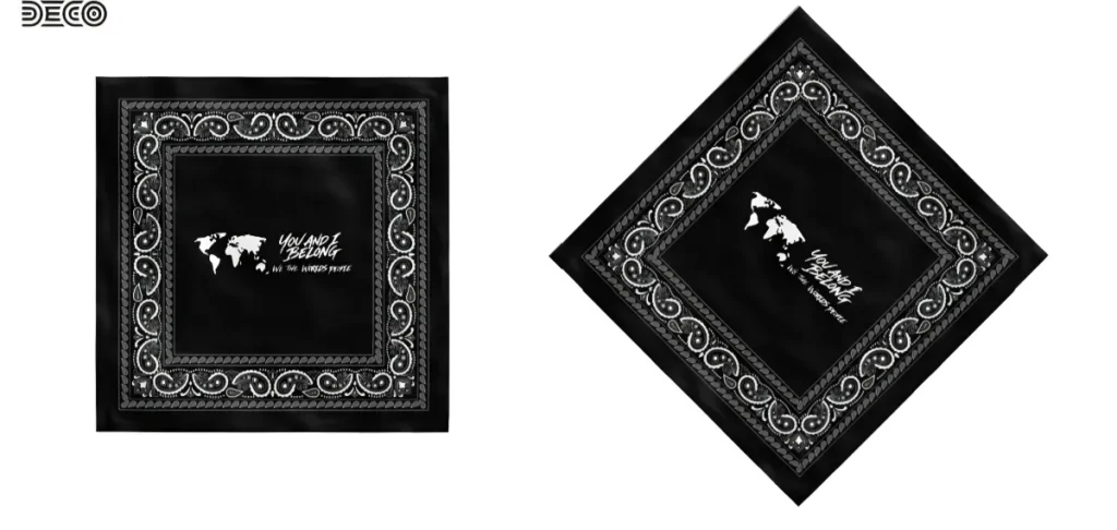Flat and angled product views of a black bandana featuring a white paisley border and a white You and I Belong world map logo in the center.