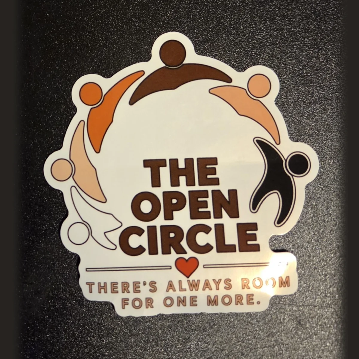 The Open Circle sticker: a ring of people in skin-tone colors around the words The Open Circle, with the line There's always room for one more